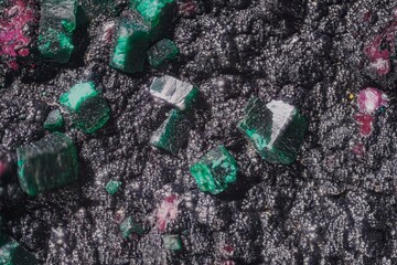 Macro photo crystals. Dioptase mineral: (cobaltocalcite pink; heterogenite black spherulites) copper silicate, DR Congo. Microphotography- 3.7X zoom magnification