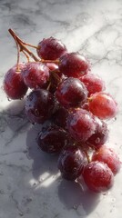 Fresh red seedless grapes on a textured surface