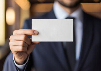 Business professional holding blank card in elegant office setting