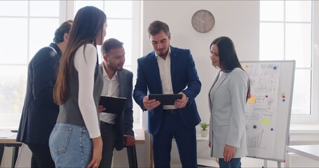 Boss conducts a presentation or meeting with employees in an office setting. Business team collaborates through people communication, discussing strategies, and ensuring staff involvement. - Powered by Adobe