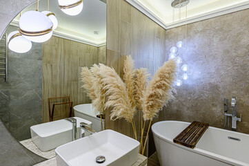 Elegant bathroom with modern fixtures. Pampas grass adds a touch of nature