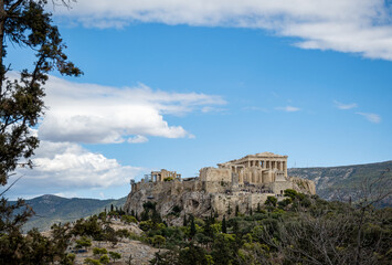 Front view photo of the Acropolis of Athens . Blue sky with clouds at the background.