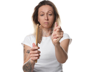 Alopecia problem. Woman taking her lost hair from brush on white background