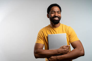 Photo of beaming black cheerful positive kind friendly business trainer having done his teaching project to be shown to his students.