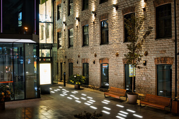Modern Illuminated Brick and Glass Building Exterior at Night in Tallinn