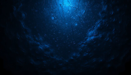Abstract dark blue underwater texture with light rays and bubbles