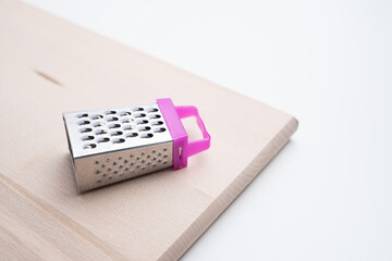 Metal cheese grater on a white background. Kitchenware.