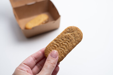 Cookies, handmade cakes, homemade baked goods in craft packaging. A girl's hand takes cookies out of the packaging. Sweet food, snack.