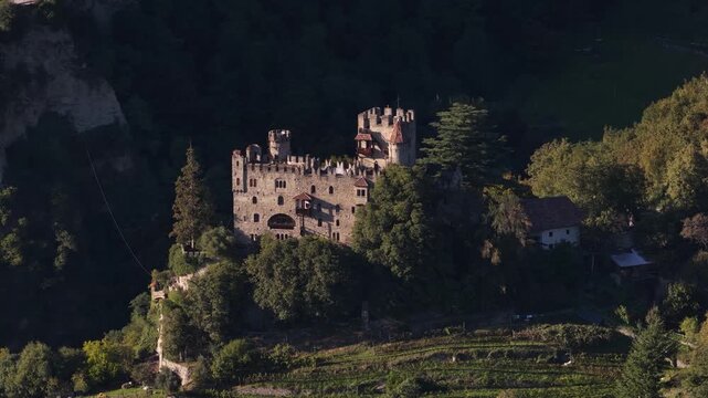 Brunnenburg castle on alpine slopes in Tirol, Italy.