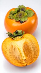 Two persimmons, one whole and one halved, on a white background