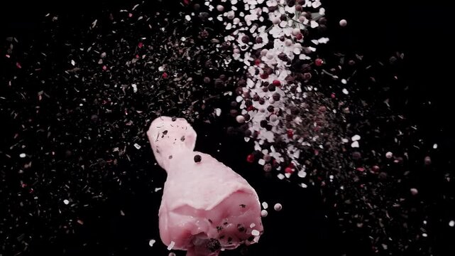 The collision of spices with a chicken drumstick in the air at super slow-motion 1000fps