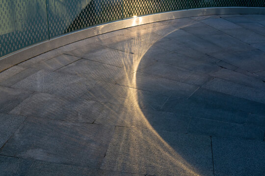 urban background, sunlight and shadow on the stone walkway in the city