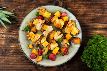 Chicken meat with pineapple on skewers.
