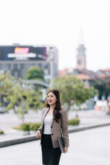 Confident Asian Businesswoman Walking Outdoors