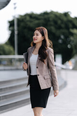 Confident Asian Businesswoman Walking Outdoors