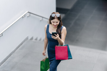 beautiful asia woman female pleased positive casual shopping hand hold paper bags happy woman enjoy...