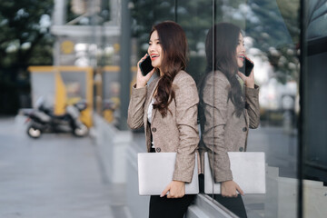 Smiling Businesswoman on Phone with Laptop