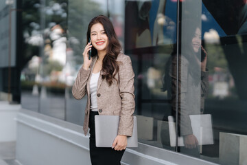 Smiling Asian Businesswoman on Mobile Phone