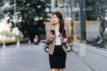 Confident Businesswoman Walking with Mobile Phone
