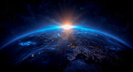 Fototapeta premium A blue, glowing earth with the sun rising on it, against a dark background.