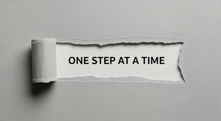 Inspirational message revealing 'One Step at a Time' through torn paper, perfect for motivation, goal setting, and personal growth campaigns or presentations