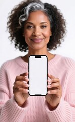 Fototapeta premium African American woman is holding a modern mobile phone with white screen