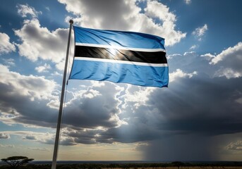vibrant botswana flag waves under dramatic sky, with sunbeams piercing through clouds. pride and identity theme. travel, national day, social event