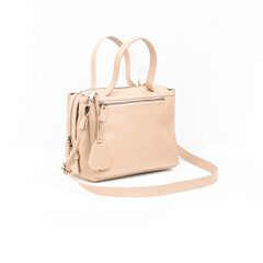 Beautiful leather bag for women in beige color open and empty isolated on white background