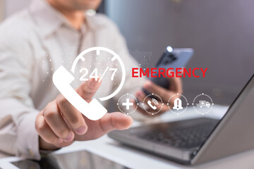 A person is reaching out to a screen displaying emergency contact information, emphasizing 24/7 availability for urgent situations.