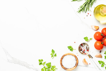 Kitchen table with herbs, spices and vegetables.
