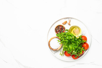 Kitchen table with herbs, spices and vegetables.