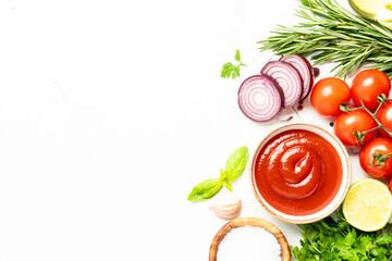 Kitchen table with herbs, spices and vegetables.