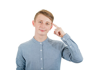 Clever teenage guy portrait pointing forefinger to his temple as looks to camera with confidence....