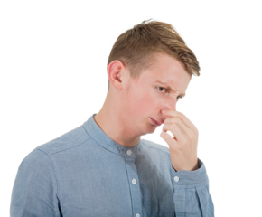Frustrated guy teenager pinching and covering his nose with disgust on face due to bad smell. Discontented young man adolescent portrait isolated on transparent background