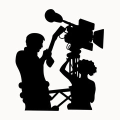 Silhouette of two people working with a large television camera on a tripod in a studio setting