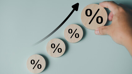 Growth concept with wooden blocks displaying percentage symbols and an upward arrow, representing business growth, financial increase, economic progress, investment performance, and success strategy.