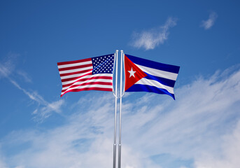 flags of  cuba and United States of America over blue sky background.