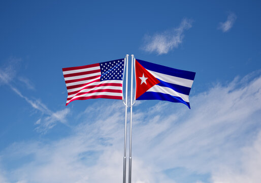 flags of  cuba and United States of America over blue sky background.