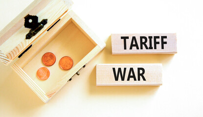 Trade tariff war symbol. Concept word Tariff war on beautiful wooden blocks. Beautiful white paper...
