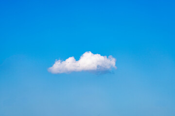 A lonely little white cloud in the blue sky