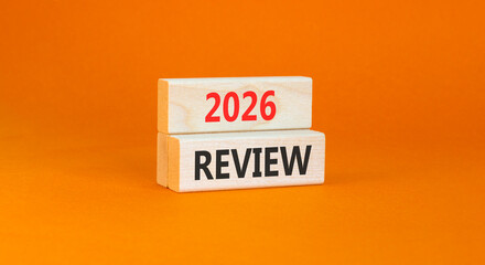 2026 Review symbol. Concept words 2026 Review on beautiful wooden blocks. Beautiful orange paper background. Business and 2026 review concept. Copy space.