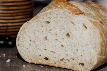 Freshly baked bread loaf cut in half, displaying its soft and chewy texture. Ideal for culinary and food-related themes in recipes or bakery advertisements.