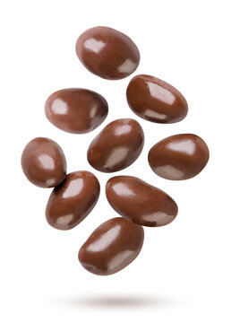 Chocolate covered peanuts flying on a white. Isolated