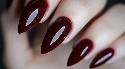 Beautiful red nail polish on well-groomed nails showcasing a glossy finish and elegant shape in a close-up view