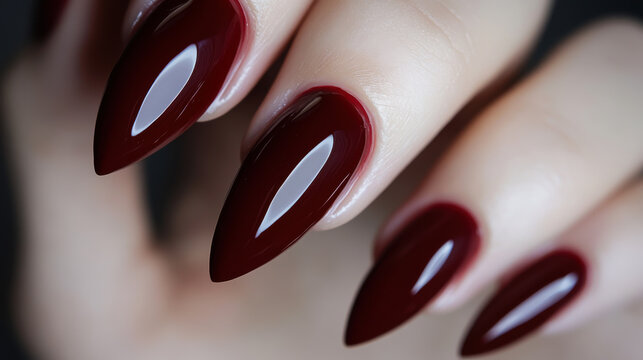 Beautiful red nail polish on well-groomed nails showcasing a glossy finish and elegant shape in a close-up view
