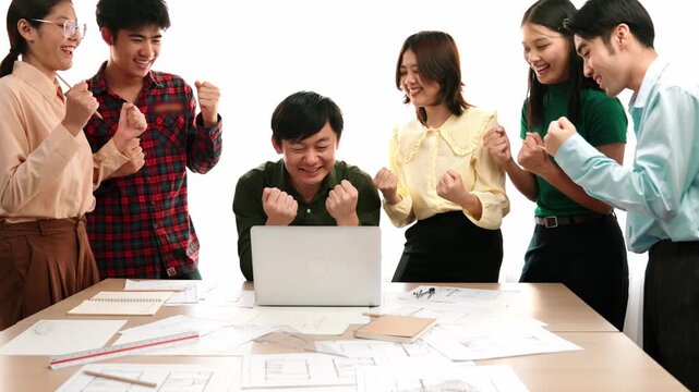 Architect and safety engineer celebrate success design building blueprint project on laptop with architectural document and measurement tool scatter around at modern office. Closeup. Delineation.