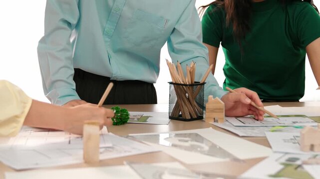 A video of architect use measurement tools and pencil to measure blueprint. Architect design house construction on a table at studio, with architectural plan scattered around. Focus hand. Delineation.