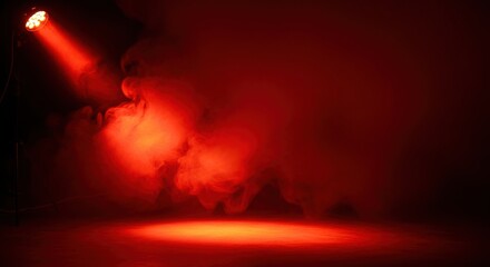 Red spotlight beam cutting through smoke in a dark room