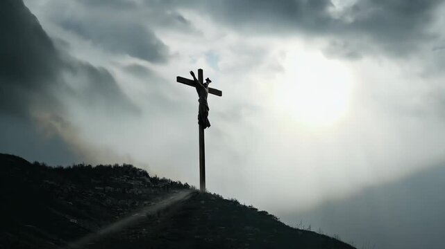 A crucifix on a mountain during approaching storm. Dark clouds swirl, focused beam sunlight breaks spotlighting crucifix. A wind tattered cloth cross. Emotional, lighting powerful cinematic mood