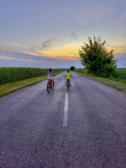 Fototapeta premium Brother and sister playing together on a rope road in the park in the village